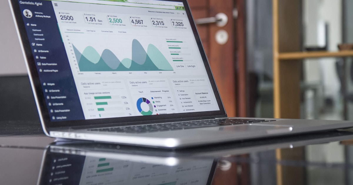 Marketer analyzing keyword research data on laptop