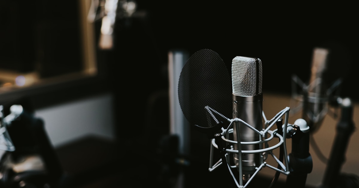 Audio waveform on screen with podcast microphone