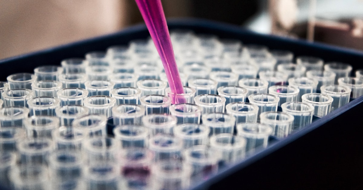 Pharmaceutical research laboratory with scientist analyzing drug compounds using AI