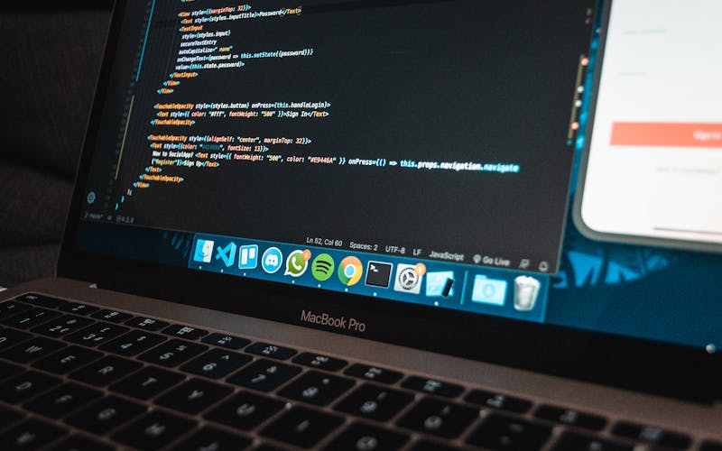Laptop showing code editor with programming language