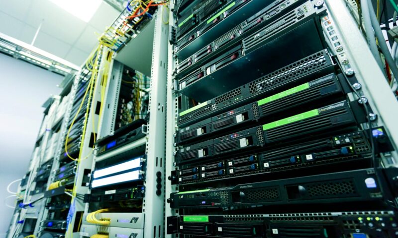 High-tech server rack in a secure data center with network cables and hardware components.