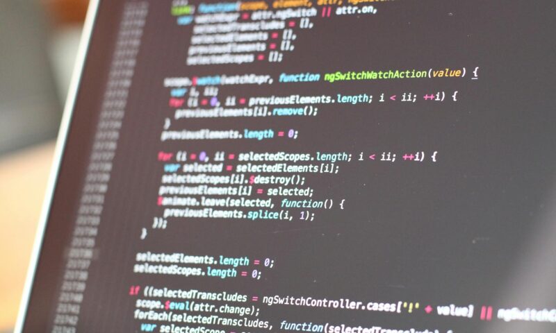 Close-up view of colorful code on a laptop screen, showcasing programming concepts.