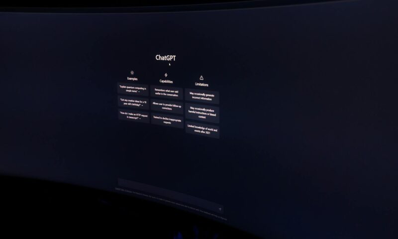 A dark, minimalist photo of a computer monitor displaying the ChatGPT interface.